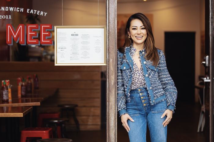 Denise Tran standing in the doorway of a Bun Mee restaurant